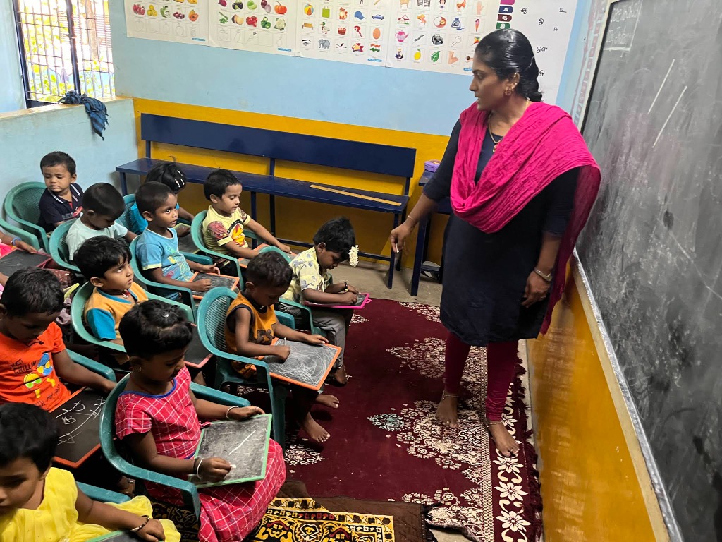 Dedicated Montessori-trained teacher guiding young students at Hara School